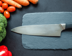 Anyone with a knack for cooking must know the value of a sharp chef’s knife. So, How Often Do You Sharpen A Chef Knife in order to experience the joy of cooking? And the perfectly sliced, diced ingredients are an additional perk! So, How Often Do You Sharpen A Chef Knife? For those who use their chef’s knives on the regular, you can sharpen your knives after every 3 to 4 uses. You can get it professionally cleaned and sharpened one to two times a year. And for those who rarely use their knives or don’t use them at all, it is recommended that you sharpen them at least twice a year. This will make your knives last for a longer period of time and in better conditions and will also prevent the blades from becoming dull which is more dangerous to work with. The most common way to sharpen your knives is by using a whetstone or a diamond rod. This helps maintain the quality of the knife and make sure it doesn't do any harm to the knife. By using this equipment you can avoid lessening the lifespan of the knife. How To Sharpen a Chef’s Knife Here are the steps to sharpen your chef’s knife Set your Knife down on the countertop with its handle facing away from you. Place something underneath the Chef’s Knife so that the blade is out of contact with anything, even just slightly. Now pick up your Chef’s Knife sharpener in your hand, making sure that you are using either a whetstone or a diamond rod for this task. These types of sharpeners are designed to be used on Chef Knives, so they are the best ones for this job. And by using the wrong type of sharpener for your knives, you will end up ruining them and making them even duller than they were, to begin with. With your Knife sharpener firmly in one hand, you should hold down the Chef’s Knife by the handle with your other hand at a 15-degree angle from perpendicular to the blade. Make sure that if you were looking straight down at the Knife, it would make an upside-down 'V' shape (if not, try again). Now drag your Knife sharpener across the Knife's edge in smooth strokes 5 - 10 times. You will want to drag it evenly across all sides of the blade without digging too deeply into any part of it. If you find that you can't get a smooth and even edge, try to lift up your knife sharpener every three strokes so that the edge of the Knife doesn't have any deep gouges or nicks in it. Once you are done with this process, you should flip over the Knife to examine the other side. If there are still deep gouges or nicks in the blade, go back over it for another minute using the same technique. Then again check both sides. If both sides of your Knife are even and smooth without any deeper gouges or nicks, then congratulations! Your Chef’s Knife is now ready to use. A Guide To Sharpening Your Chef’s Knife Should You Push Or Pull While Sharpening A Knife Chefs can sharpen their knives in many different ways. They may use Chef’s Knife Sharpeners to keep their knives in tip-top shape for professional and home use. When Chefs Push their Knives, they will press down on the Knife Sharpener with firm force, bringing the edge of the blade against an abrasive surface until it meets a metal stop. Make sure that as much steel as possible is ground away from the blade. Chefs should keep their blades perpendicular to surfaces at all times. They should also be sure to keep Chef Knives, Knife Sharpeners, and Chef's hands and fingers well out of the way so as not to cause injury should a slip occur. Chefs can also choose to pull their Knives instead of pushing them when sharpening their Chef’s Knives. This process involves placing the Chef Knife Sharpeners beneath the blade itself, with its abrasive surface facing towards one end of the blade (this is called drawing the knife) and then pulling it back along this surface until it reaches the other end. Again, chefs should make sure that they hold Knife Sharpeners and Chef's other hand well away from the edge of the blade and be careful not to nick their fingers in the process. How Can You Know If Your Knife Is Sharp Chef knives are used in the kitchen for chopping and slicing food, such as meats and vegetables. Many people who enjoy cooking want to own several knives so that they have the right one for each task: paring knives, utility knives, serrated steak knives, fillet knives, and chef's knives just to name a few. Chef's knives are often the most versatile kitchen knife available. They can be very expensive pieces of equipment, which means that they should last a long time with proper care. Cooks who use chef’s knives every day to prepare their food quickly learn that it is important to keep their knives sharpened. A sharp blade enables cooks to slice or dice through foods with ease - without exerting a lot of effort. Using a dull chef’s knife makes chopping foods more difficult; when you try to cut tough vegetables like carrots or celery with a dull blade, it causes the food to shift around and move instead of allowing your knife to slice through smoothly and quickly without any effort. If you have ever tried using a very dull chef knife, you know how difficult it can be to cut vegetables evenly and thinly because your knife keeps sticking on the food instead of easily slicing through it. You may also find yourself forcing down harder on your knife to help push through the tough vegetable, which can cause injuries. When you see a shiny metal strip on the cutting edge, that's your cue. That shiny metal strip is where it came from the factory, and now it has been ground away from repeated use. Your kitchen knives will go dull with time as well as rusting due to their exposure to corrosive elements in food and air after each use. To keep them at their top-notch of usability at all times, you must maintain them for continued sharpness. You can test your edge by slicing through an index card held horizontally with your eyes closed. If you feel the edge tear instead of cut, then it's time to take your blades in for professional service. There are several ways that you can do it at home however since you probably won't want to send your prized knives to a professional for sharpening every time you need them. Is It Possible To Ruin A Knife By Sharpening It No, you cannot ruin a knife by sharpening it. The reason for this is that by sharpening the blade you are only removing the outer layer of steel from it, and there will be nothing that can harm you in doing so unless you use a grinder with an extremely coarse wheel. The best way to think about this is to look at a piece of paper, what would happen if you cut through layers of paper with a pair of scissors? The answer is simple: it would make them shorter but still perfectly functional. It's exactly the same thing with knives, once all they have been ground down to is their core metal most blades will be useless as they will lack structural integrity. However, if the metal has simply been thinned and is still functional then there is no danger to you, it can't suddenly snap on you or anything like that. The only time that you might ruin a knife by sharpening it would be if it was so blunt as to require coarse grinding stones, but this will almost certainly be apparent as such knives do not easily slice through materials. Sharpening these knives may result in the blade snapping as they simply cannot hold their shape when so thin! This is why it is recommended to use diamond sharpener accessories: they work on just about every kind of blade and ensure that even if your knife has gone extremely blunt, it will still recover its former glory without having any need for Coarse Grinding Stones. Before you finish reading this post you might wanna check out some Cooking related products recommended by The Reds Cafe, which will add up to your Cooking experience. Things To Know Before You Learn How Often Do You Sharpen A Chef Knife Do Chefs Sharpen Their Knives Chefs have a love-hate relationship with their Chef’s knife. They hate having to keep it sharp, but they can't live without it! Chef's use a Chef knife for just about everything - chopping vegetables, slicing meats and the list goes on. Keeping your Chef knife at its best is essential to being a great chef! Chef knives are extremely valuable, intricate pieces of equipment to chefs. They can range from a few hundred dollars to thousands of dollars or more per knife. Thus, most chefs take care of their precious utensils and make sure they remain as sharp as possible. In fact, many chefs even go the extra mile and sharpen their own knives! Chef knives require maintenance in order to keep them sharp. They need to be cleaned properly, dried correctly, and stored with ease. Sharpening a chef knife is simple enough - but you still have to know how often it needs to be done by a professional. Even if the knives are not much in use, they need to be sharpened at least one to two times a year. However, this doesn't seem to be the case for every chef, although it can be done for keeping the knives in better conditions for longer periods of time. What Is Used By A Chef To Sharpen Their Chef’s Knife The answer: whetstones. There are two types of whetstones that most Chefs use; one type is the natural stone that comes in many different shapes and sizes. The other type is an artificial stone which you can get in flat or round forms for easy handling. Before even touching the knife to the Chef's choice of whetstones, they do a couple of things... To get the Chef’s knife ready for sharpening, Chefs will first make sure that their knife is absolutely spotless. They will clean off the blade by wiping it down with an old rag or towel. They also make sure to take any removable parts off of the knife (like screws) out, because they could be lost while you sharpen it. Once everything is in order and all other knives are put away, Chef then selects their whetstones. If they want an even edge on their knife they would use two whetstones; one shorter stone or "Waterstone" with medium coarseness and one longer stone or "oil stone". They will use the coarser Waterstone first and then finish off with the finer oilstone. They can also choose to go on their knife without finishing with an oilstone, this method is called 'freehand sharpening' and is mostly used for Asian Chef’s Knives. To sharpen, Chefs lay their knife flat against the whetstones in a smooth arc pattern. They keep their thumb pressed lightly against the back of the knife blade to ensure that they are applying even pressure across the whole blade. Chefs repeat this motion along with all parts of both whetstones until either there are no nicks left on the knife or they aren't satisfied with the edge. They then wipe the blade again before putting it away to be used.